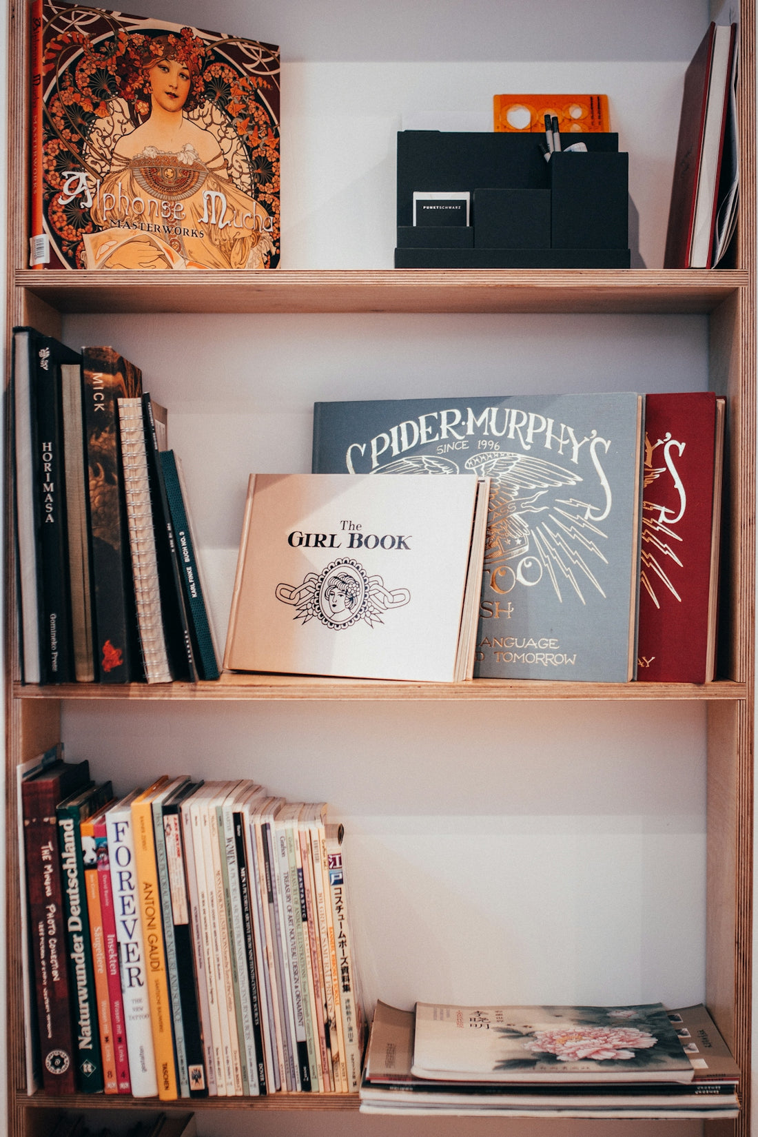 white and brown book on white wooden shelf