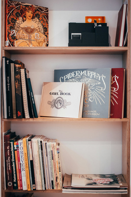white and brown book on white wooden shelf